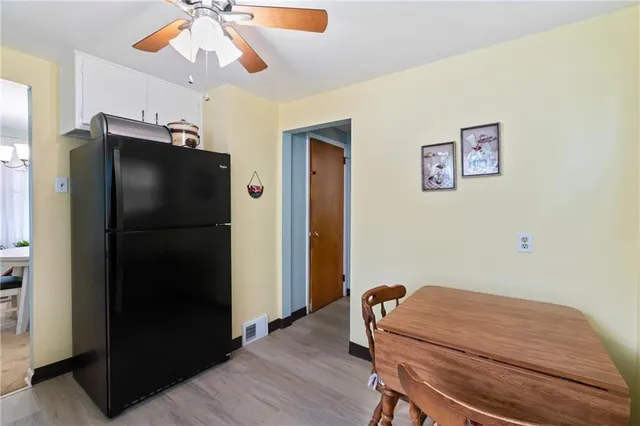 a room with a refrigerator and a chandelier