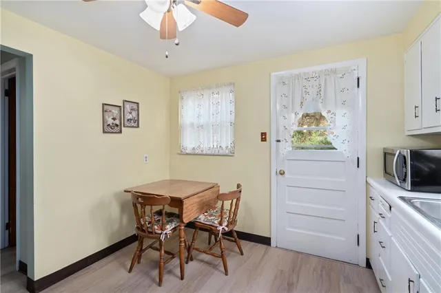 a view of a dining room with furniture and a window