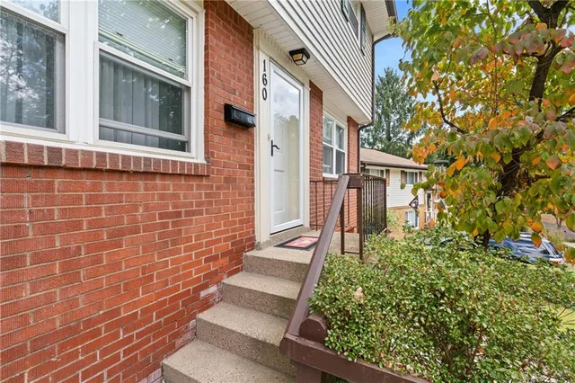 a view of a brick house with a large windows
