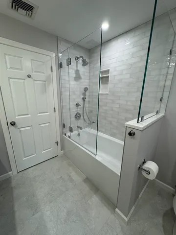 a bathroom with a shower and a toilet