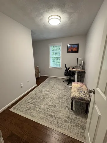 a living room with a bed furniture and a window