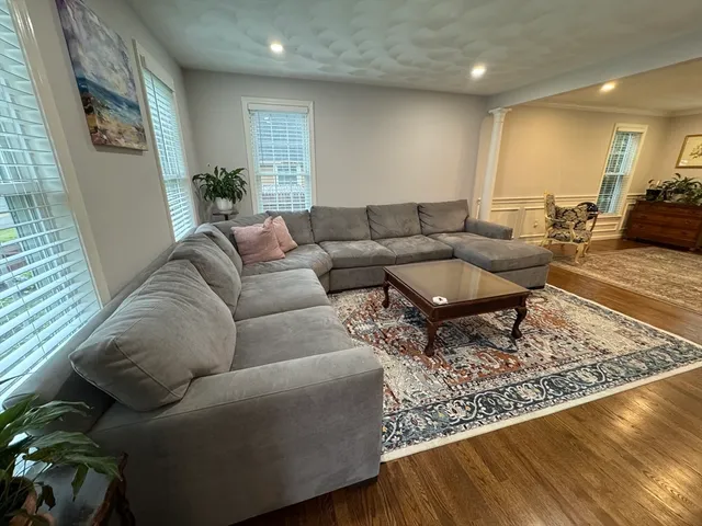 a living room with furniture and wooden floor