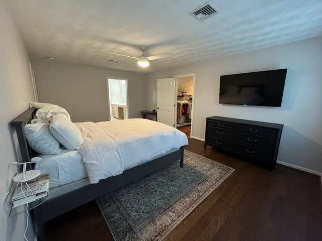 a bedroom with a bed and a television in it