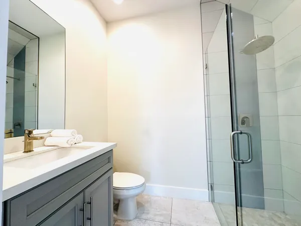 a bathroom with a sink toilet and shower