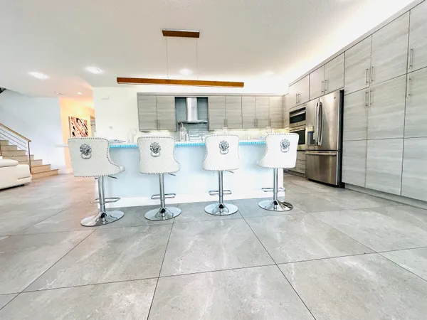 a room with gym equipment and stainless steel appliances