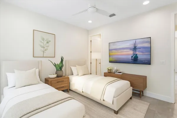 a bedroom with a large bed and a flat screen tv