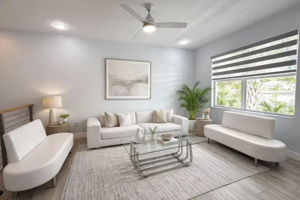 a living room with furniture and a large window