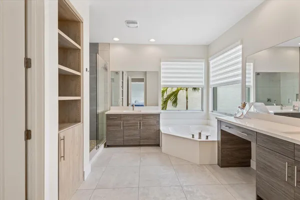 a bathroom with a tub sink and mirror