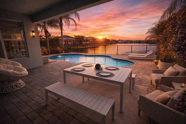 a view of a patio with couches table and chairs and potted plants