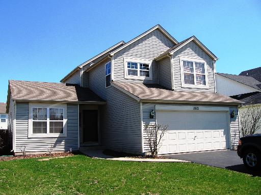 1912 Spring Ridge Drive Plainfield, IL 60586 - Photo 1 of 1 a front view of a house with a yard and garage