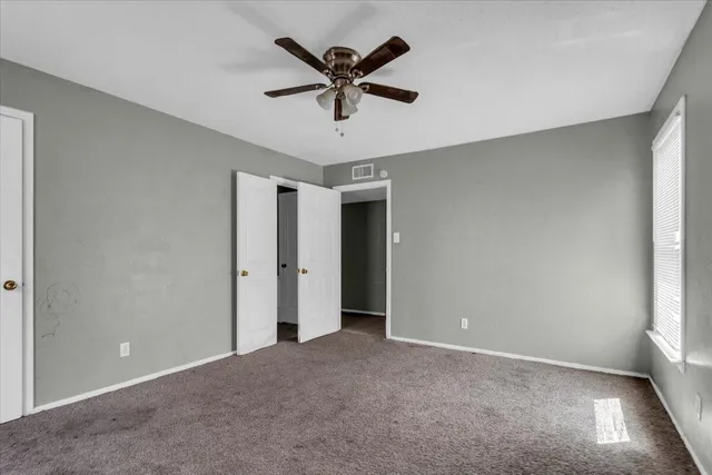 a bathroom with a granite countertop sink a toilet and a mirror