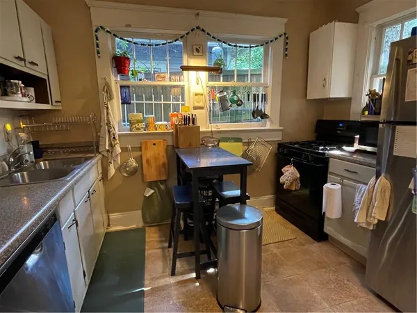 a kitchen with stainless steel appliances granite countertop a sink stove and cabinets