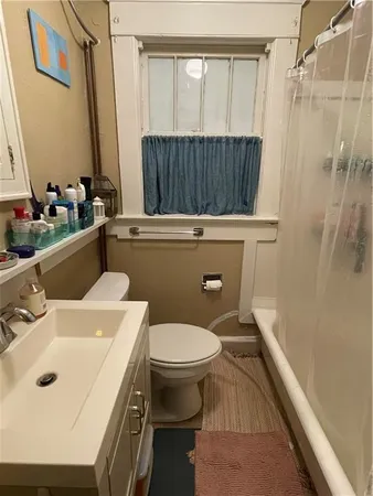 a bathroom with a sink toilet and shower