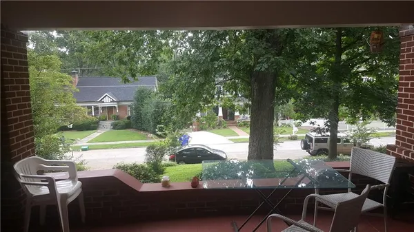 a view of yard from deck with patio