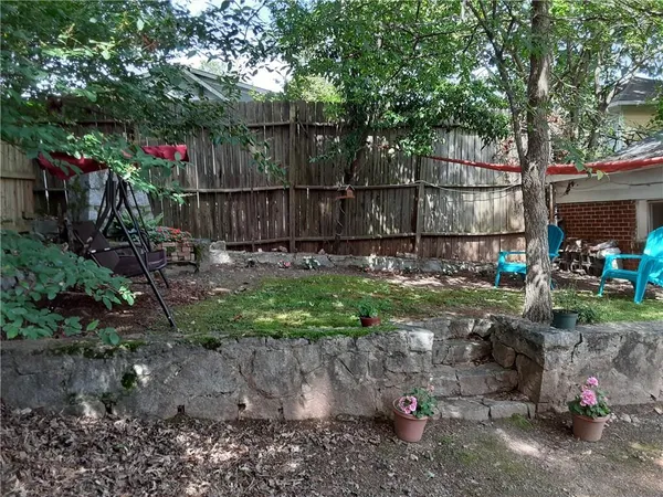 a view of a backyard with wooden fence