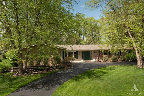 a view of a house with backyard sitting area and garden