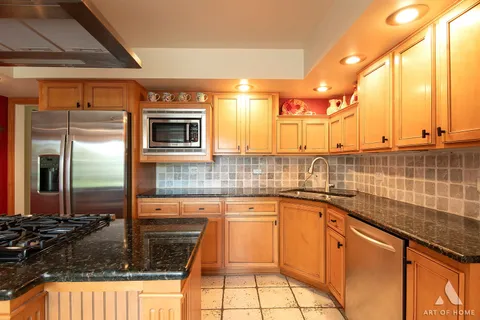 a kitchen with granite countertop a sink stove and cabinets