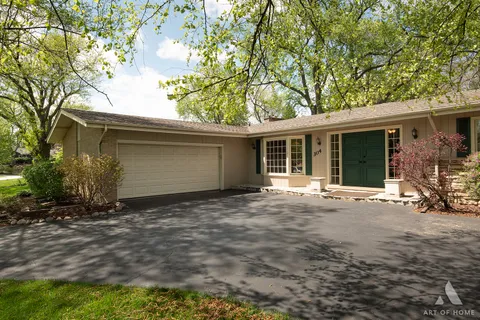 a view of a house with a tree in front