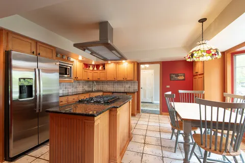 a kitchen with granite countertop a sink stove and cabinets