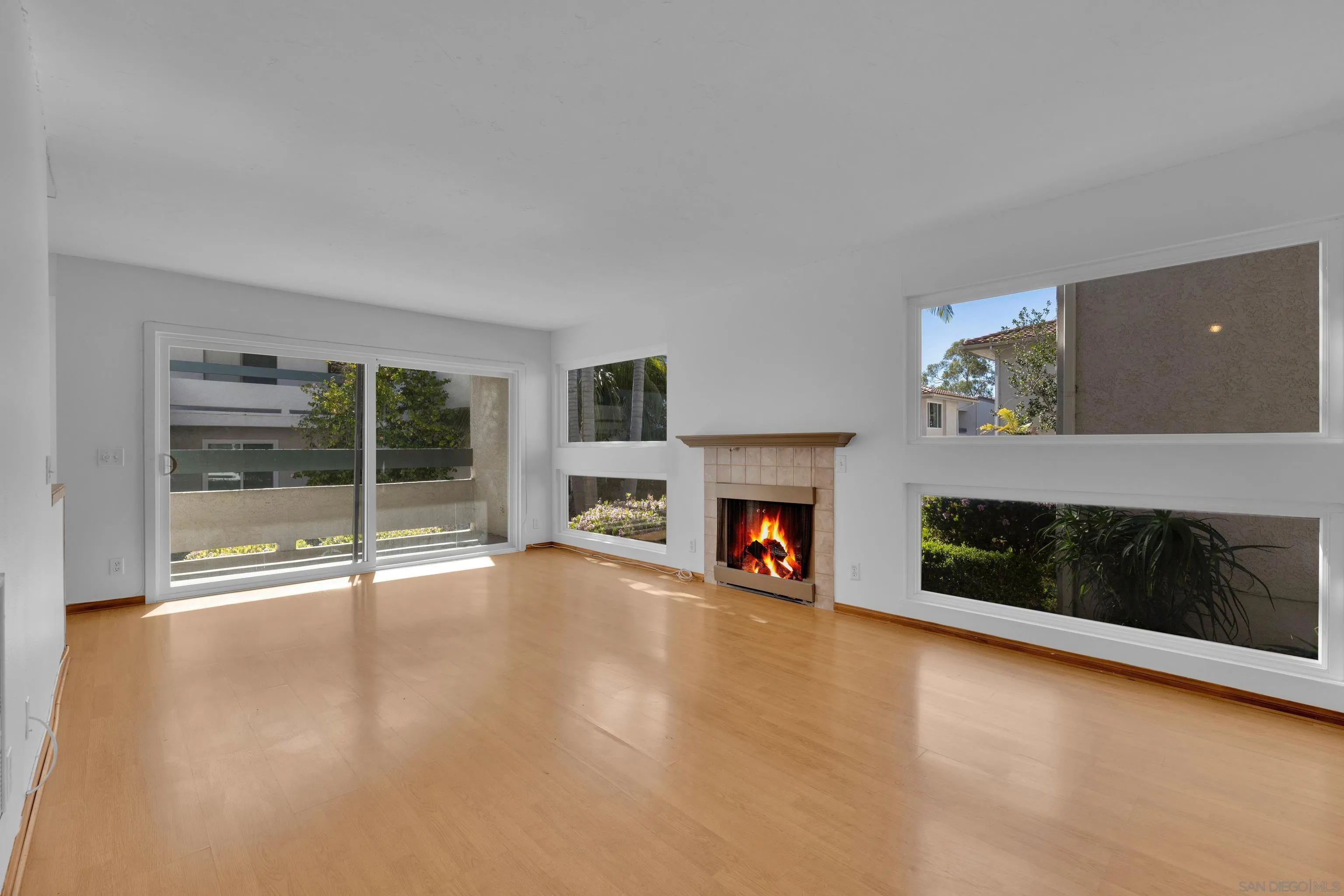 2308 Altisma Way, Unit 118 Carlsbad, CA 92009 - Photo 1 of 51 a view of an empty room with a fireplace and window