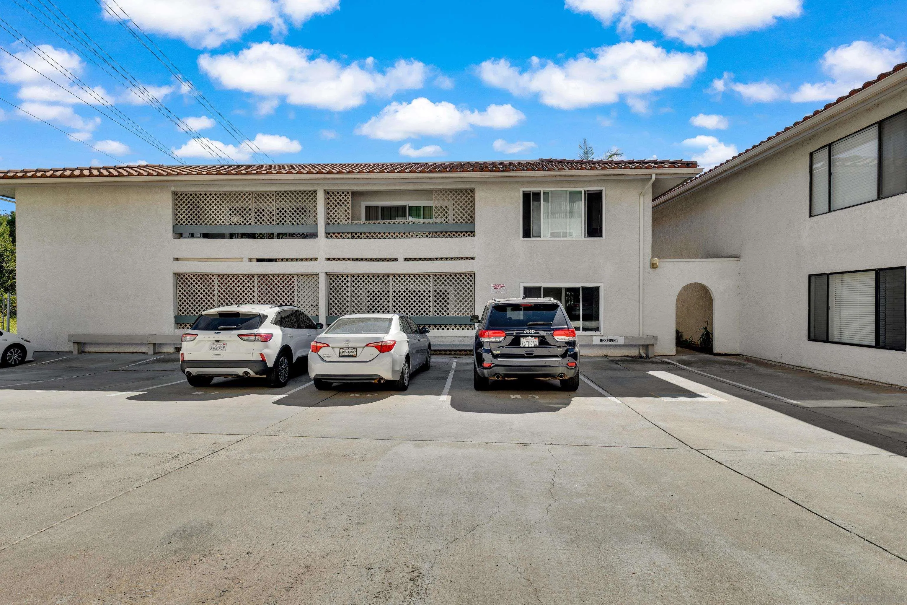 2308 Altisma Way, Unit 118 Carlsbad, CA 92009 - Photo 12 of 51 a car parked in front of a white building