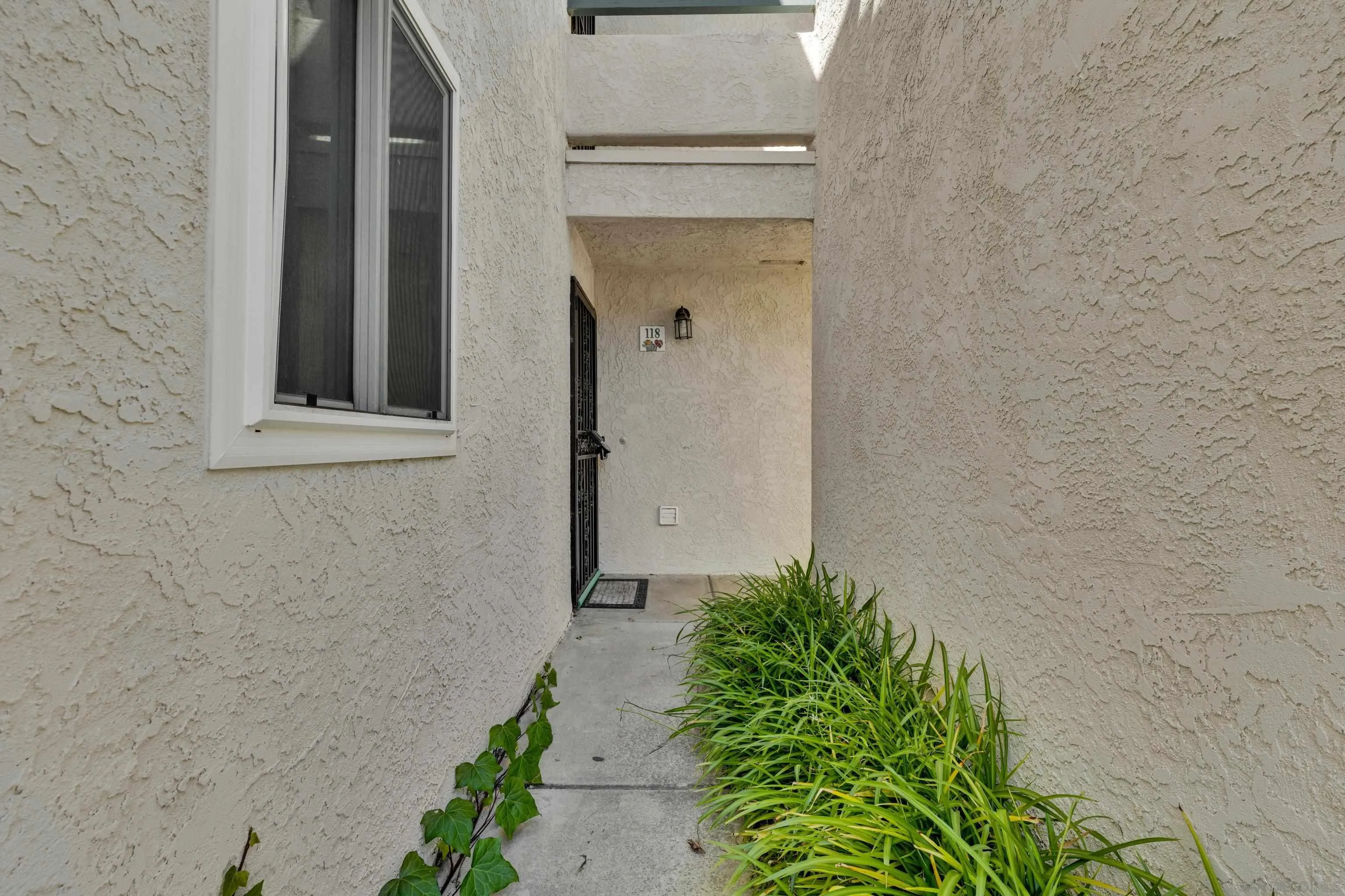 2308 Altisma Way, Unit 118 Carlsbad, CA 92009 - Photo 19 of 51 a front view of a house with a yard