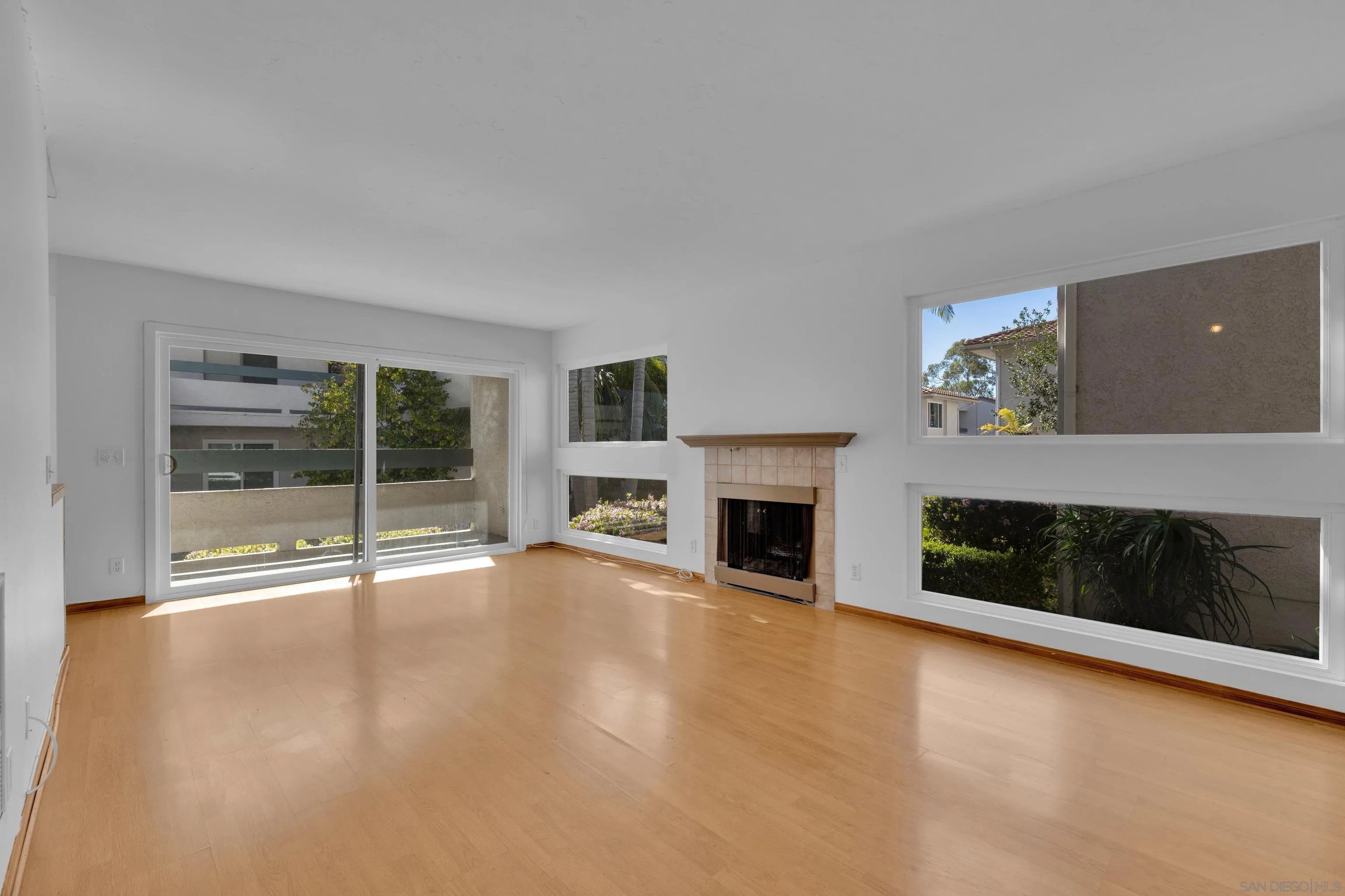 2308 Altisma Way, Unit 118 Carlsbad, CA 92009 - Photo 26 of 51 a view of an empty room with a fireplace and a window
