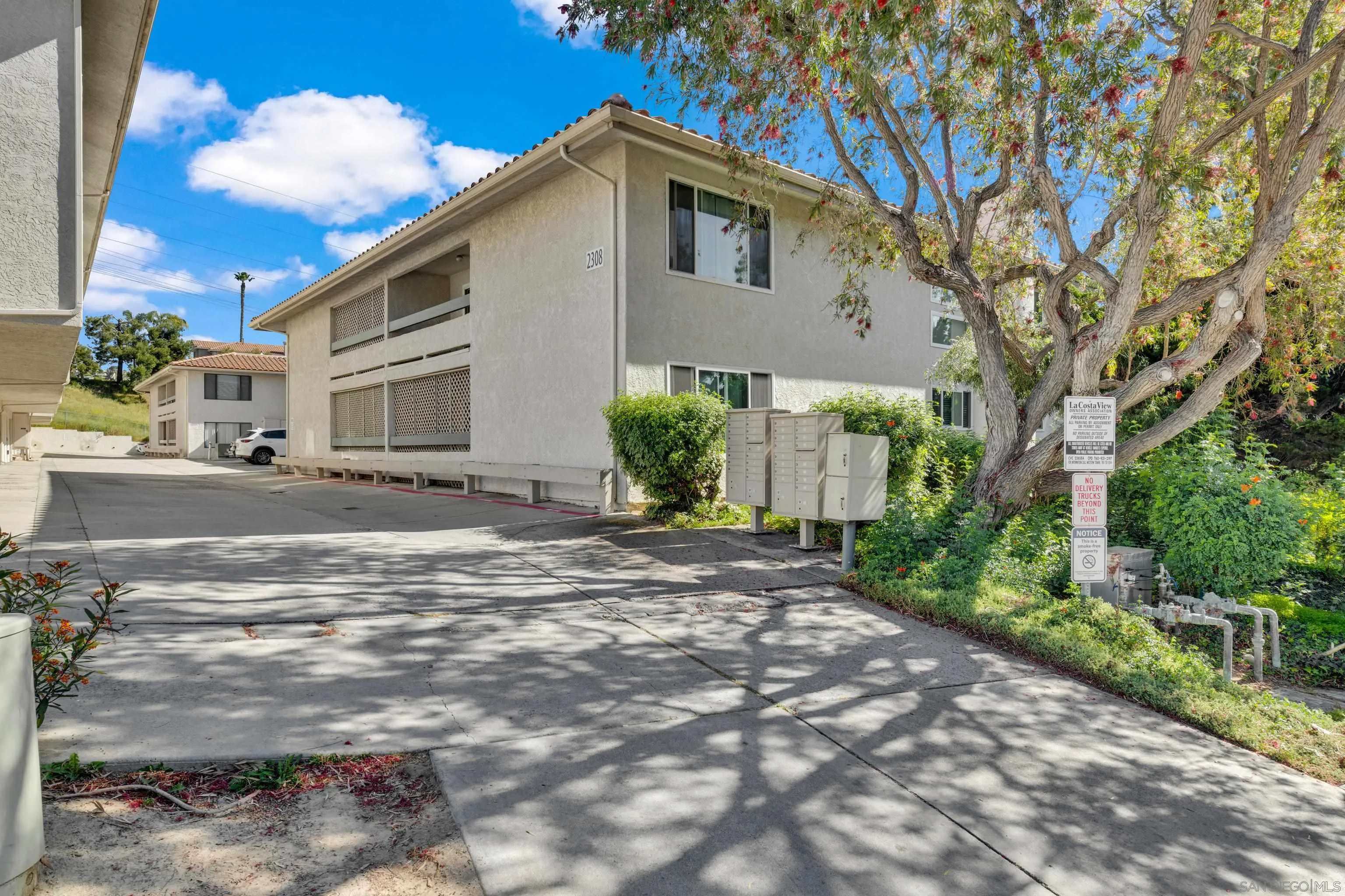 2308 Altisma Way, Unit 118 Carlsbad, CA 92009 - Photo 3 of 51 a front view of a house with garden