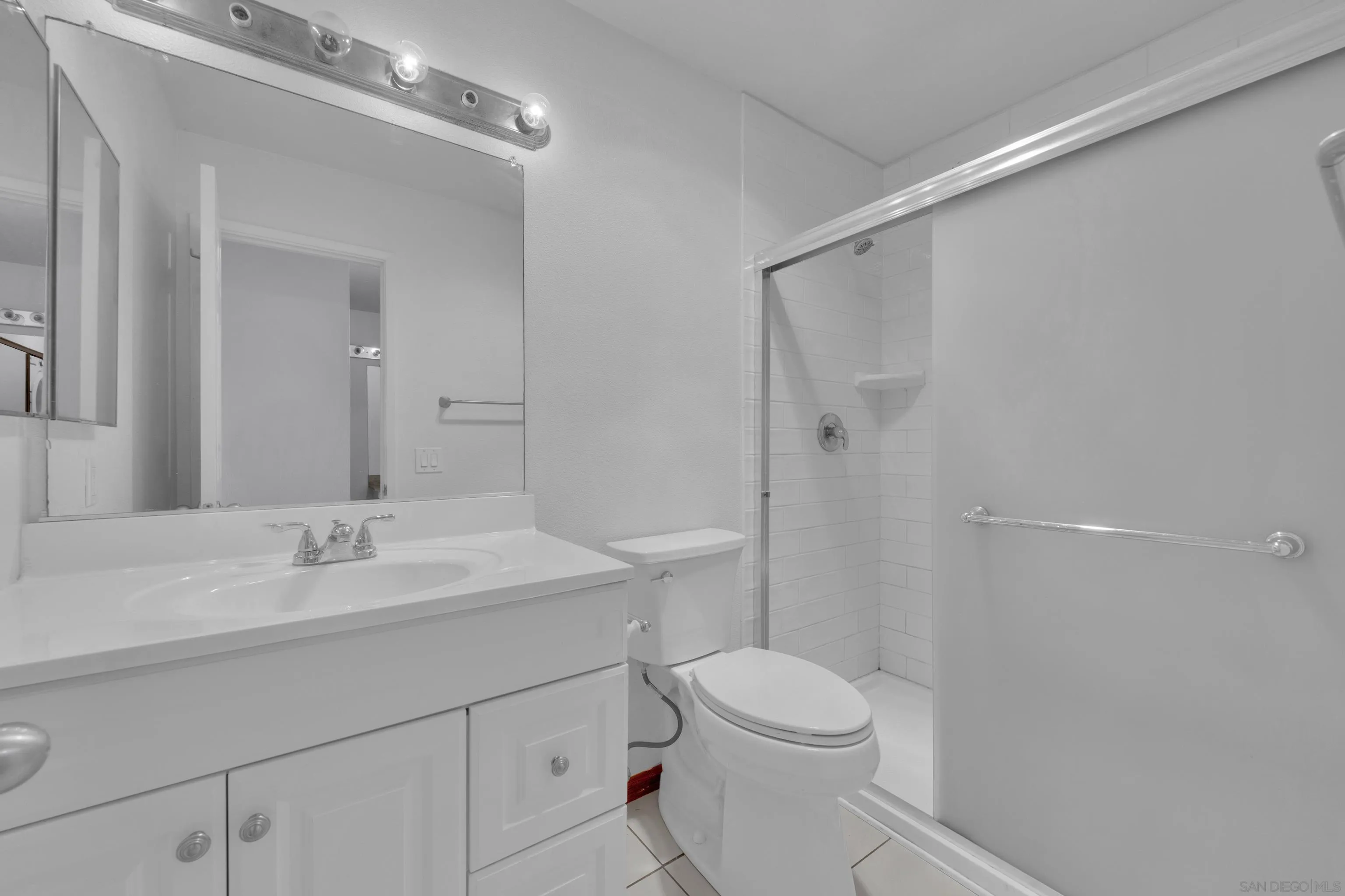 2308 Altisma Way, Unit 118 Carlsbad, CA 92009 - Photo 48 of 51 a bathroom with a sink a toilet a shower and a mirror