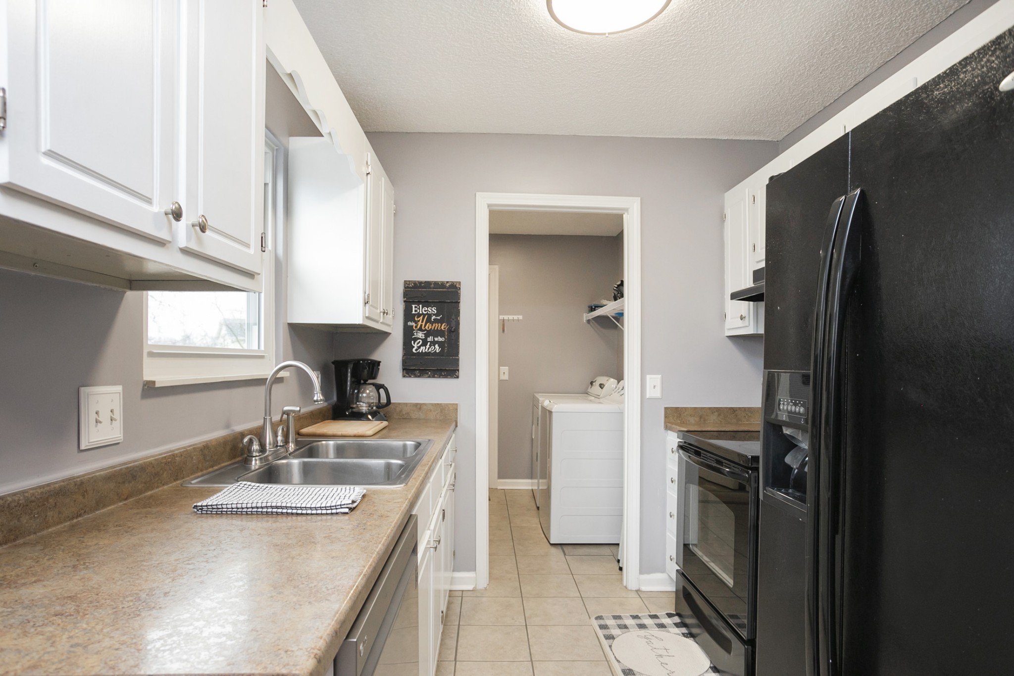 1464 Autumn Knoll Road Hermitage, TN 37076 - Photo 16 of 46 a kitchen with kitchen island granite countertop a sink stove and refrigerator