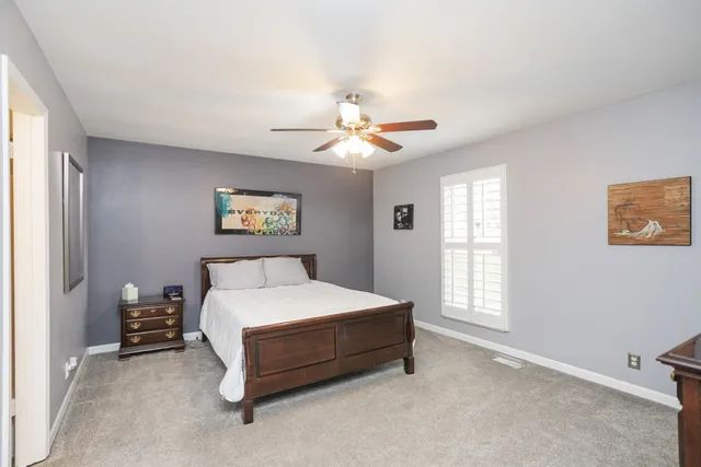 a bed room with a bed and a chandelier