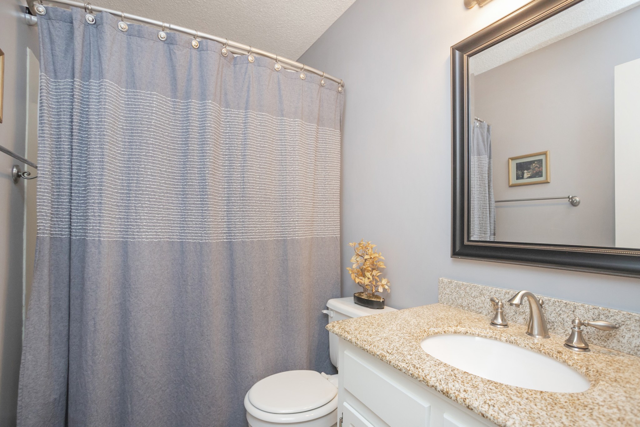 1464 Autumn Knoll Road Hermitage, TN 37076 - Photo 33 of 46 a bathroom with a granite countertop sink and a mirror