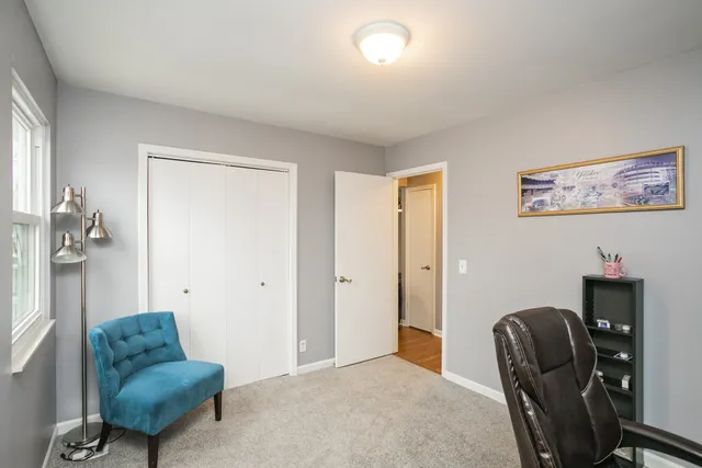 a bedroom with furniture and a chair