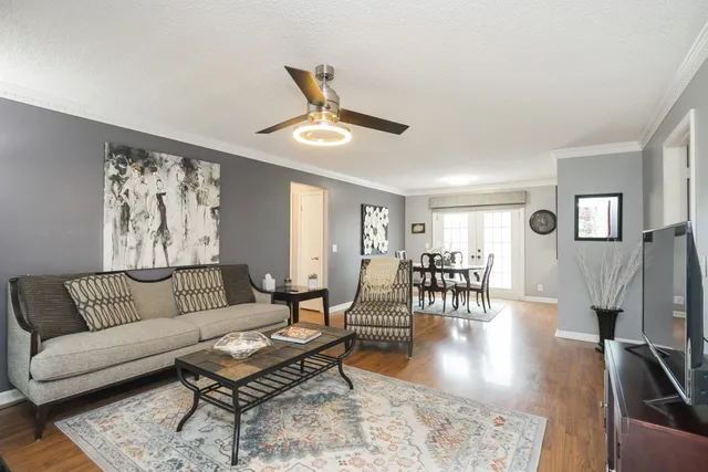 a living room with furniture and wooden floor