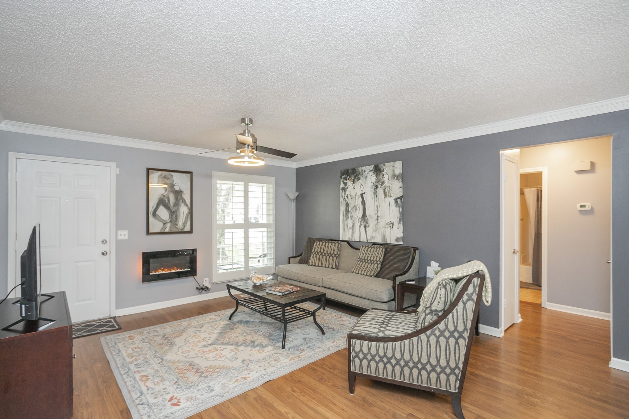 1464 Autumn Knoll Road Hermitage, TN 37076 - Photo 8 of 46 a living room with furniture a rug and a fireplace
