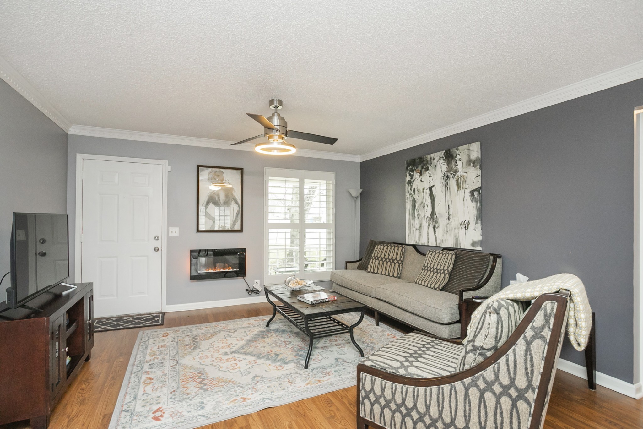 1464 Autumn Knoll Road Hermitage, TN 37076 - Photo 9 of 46 a living room with furniture a flat screen tv and a window