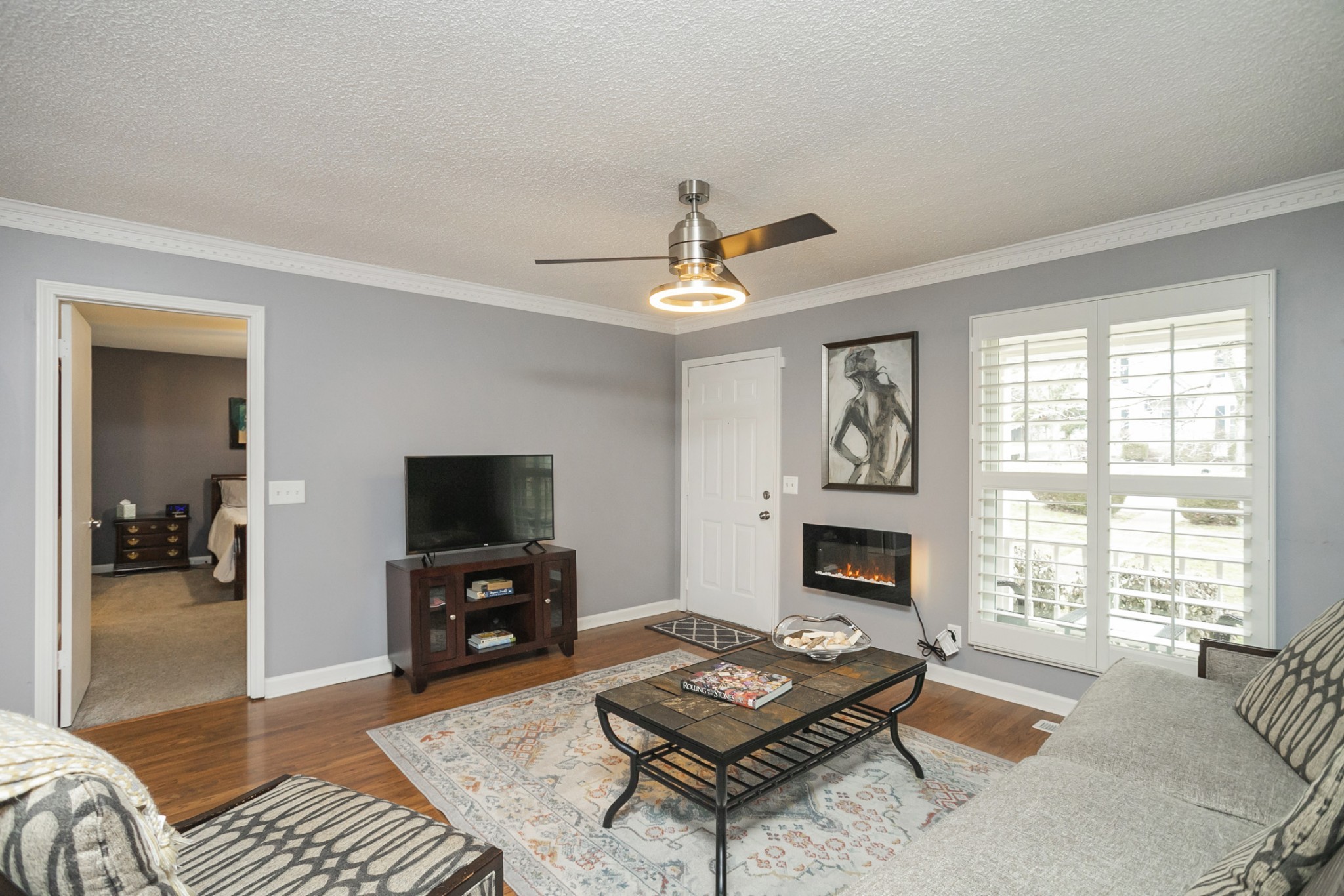1464 Autumn Knoll Road Hermitage, TN 37076 - Photo 10 of 46 a living room with furniture a fireplace and a flat screen tv