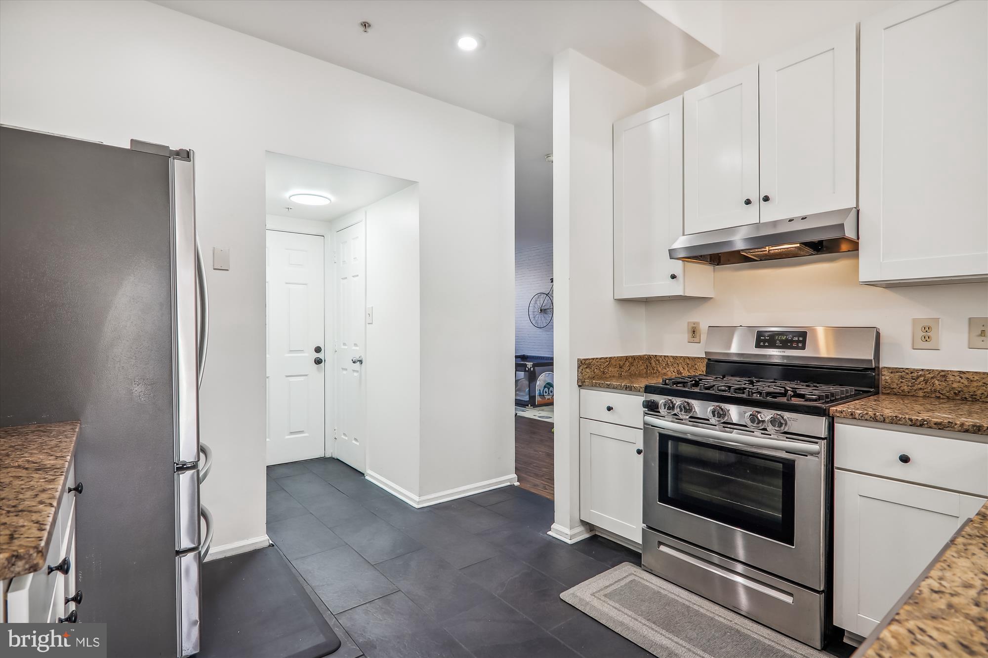 12113 Quilt Patch Lane Bowie, MD 20720 - Photo 6 of 38 a kitchen with stainless steel appliances granite countertop white cabinets and a stove top oven