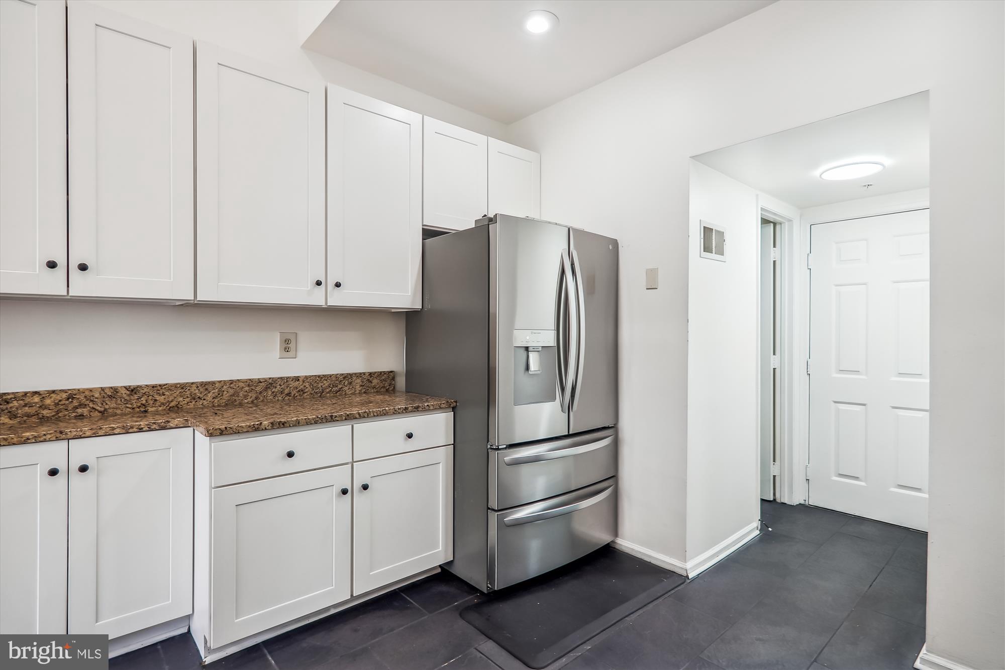12113 Quilt Patch Lane Bowie, MD 20720 - Photo 7 of 38 a kitchen with white cabinets and refrigerator