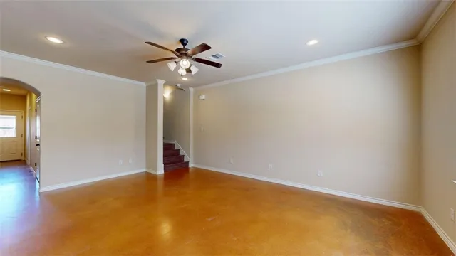 a view of an empty room with a ceiling fan