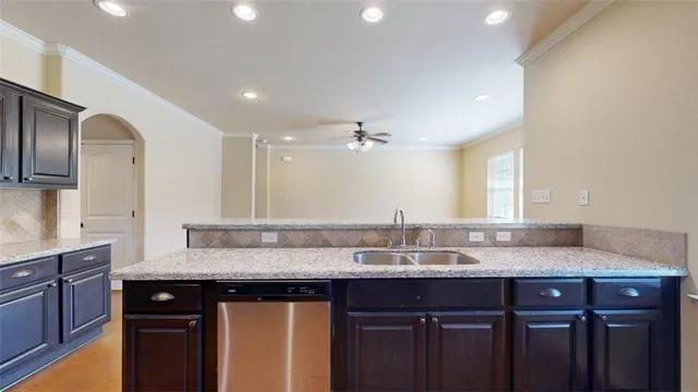 a kitchen with stainless steel appliances granite countertop a refrigerator a stove and a sink with large countertops