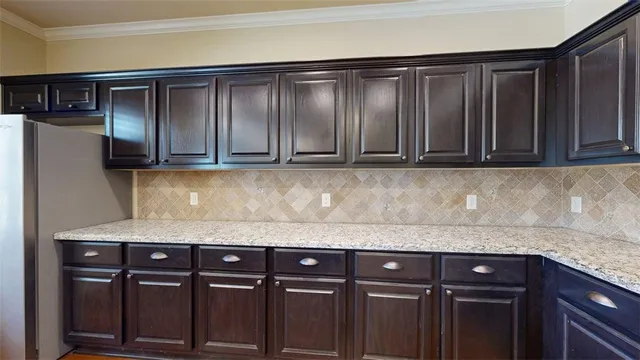 a bathroom with a granite countertop double vanity and a mirror