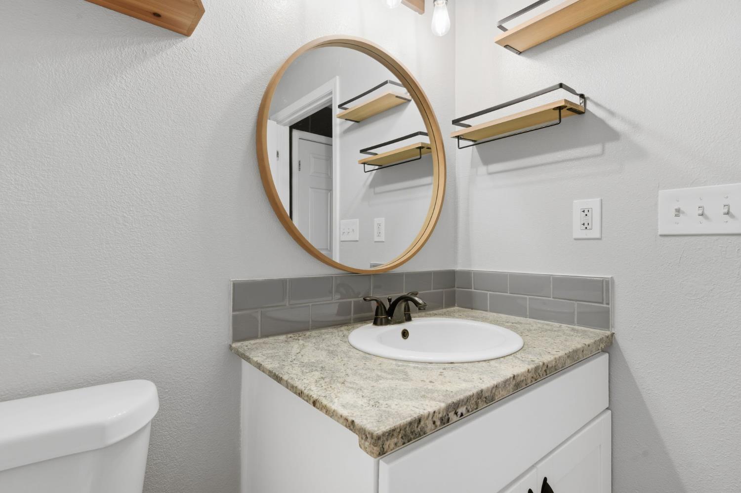 7580 Latrobe Road Shingle Springs, CA 95682 - Photo 56 of 56 a bathroom with a sink and a mirror