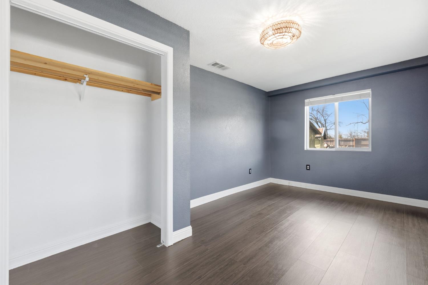 7580 Latrobe Road Shingle Springs, CA 95682 - Photo 6 of 56 an empty room with wooden floor and windows