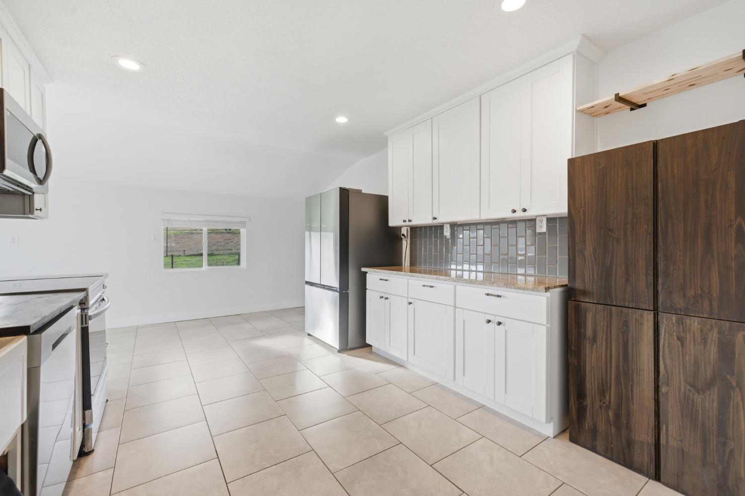 7580 Latrobe Road Shingle Springs, CA 95682 - Photo 7 of 56 a kitchen with stainless steel appliances granite countertop a refrigerator sink and cabinets