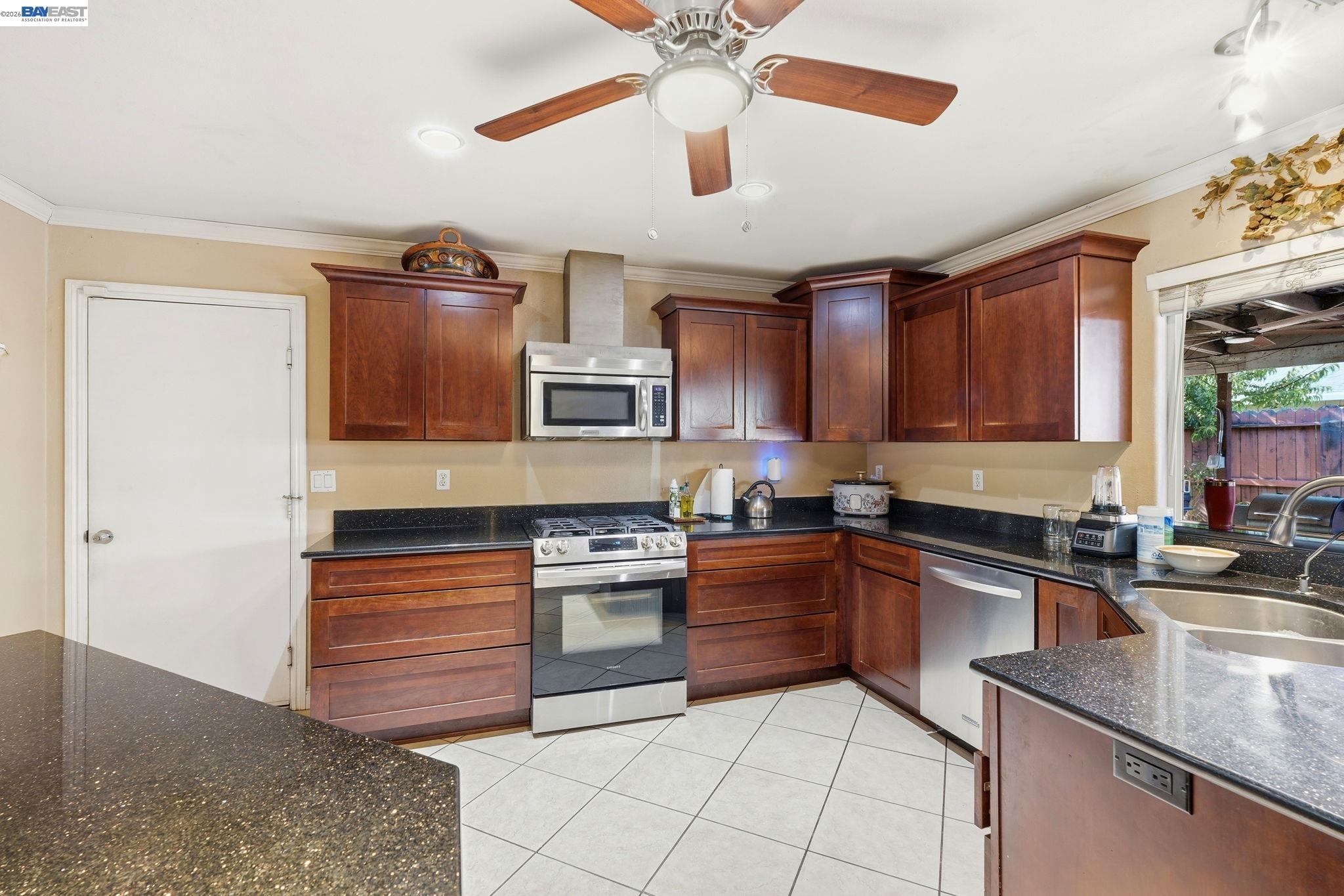 10378 South Priest Road French Camp, CA 95231 - Photo 9 of 44 a kitchen with stainless steel appliances granite countertop a sink stove and cabinets