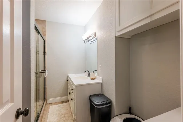 a bathroom with a sink mirror and toilet