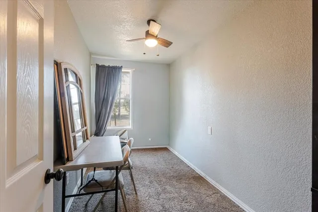 a view of a hallway with furniture and a window