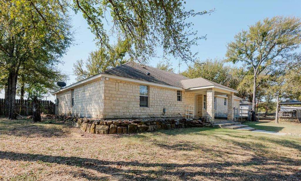 2350 Grindstone Road Millsap, TX 76066 - Photo 5 of 33 a view of a house with a yard covered in snow