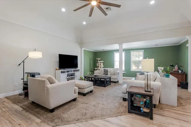 a living room with furniture and a flat screen tv